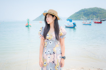 Fototapeta na wymiar Portrait young beautiful asian woman walk smile and happy on the beach sea and ocean for leisure travel in holiday vacation 