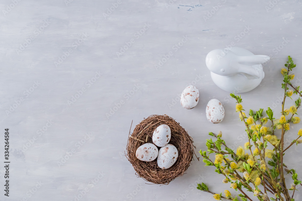 Wall mural flat lay easter composition with a willow branch and eggs on a gray background