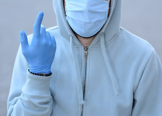  A young man with medical half face mask and gloves