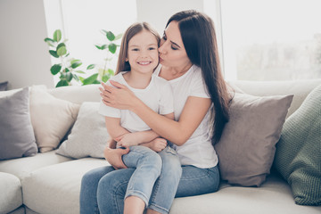 Photo of pretty little girl young charming mommy hugging holding each other close affectionate...