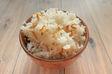 cooked indian rice in a bowl on wooden table 