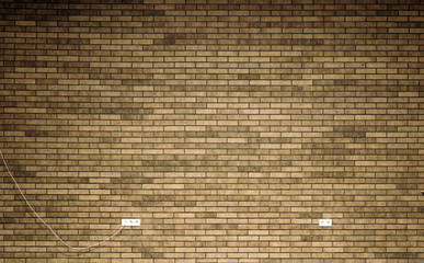 brown brick wall with sockets and wire, perfect as background / texture. place for text