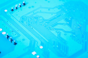 Blue electronic circuit board close-up, soft focus, background