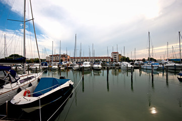 Boats waiting in the port of Caorle, a charming holiday resort and fishing village.Italy.