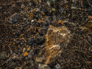 water texture stones rays sun