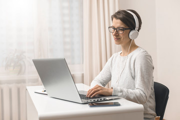 Female freelancer works on a remote house. A woman is studying online video chat on a laptop. Girl...