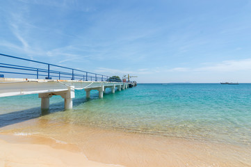 Jetty with clear water and blue skies