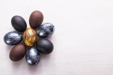 Holidays, design and modern easter concept - Black and brown easter eggs style minimalism on white background with copyspace.