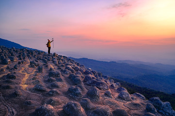 Tourists conquer the landscape stone courtyard at Phu Hin Rong Kla National Park at sunset. Phitsanulok, Thailand