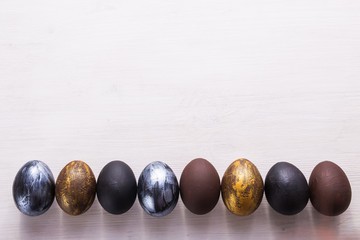 Holidays, design and modern easter concept - Black and brown easter eggs style minimalism on white background with copyspace.