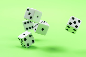 Dice being rolled on a green table.