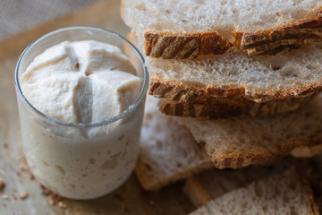 Slices of natural, homemade bread without yeast. .leaven in a glass. Starter. The concept of healthy eating and homemade food..