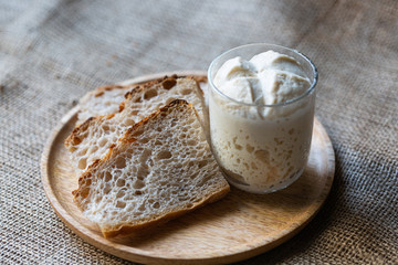 Slices of natural, homemade bread without yeast. .leaven in a glass. Starter. The concept of healthy eating and homemade food..