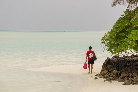 A Man From Behind Walking On A Beautiful Beach