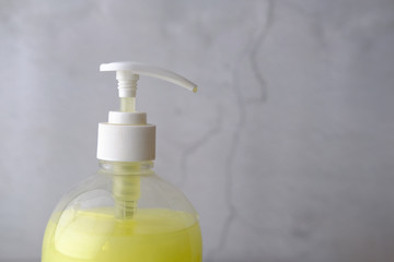Fototapeta na wymiar Liquid Hand Sanitizer Soap against wall