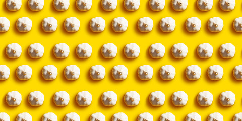 Garlic with contrasting shadows on a yellow background. Flat lay stile. Seamless pattern