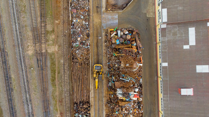 Sorting and recycling of metal waste top view. Scrap metal procurement station. Loading operations for the utilization of ferrous metals by air shooting.