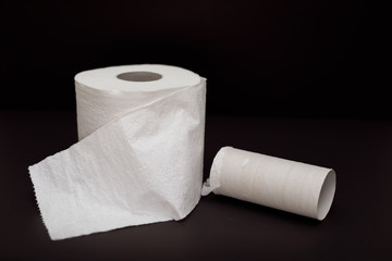 Toilet paper roll on black background