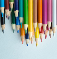 stacked colored pencils on white background