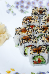 Sushi and rolls home delivery. Krpny plan. Sesame, salmon, cheese.