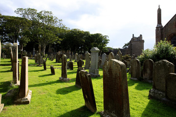 Kirkwall - Orkney (Scotland), UK - August 07, 2018: 12th century Romanesque Saint Magnus cathedral cemetery in Kirkwall, Orkney, Scotland, Highlands, United Kingdom
