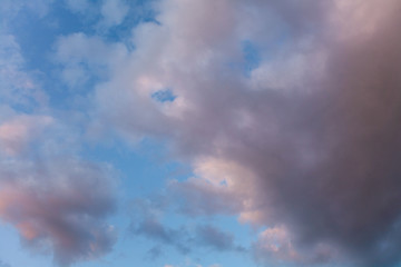 large pink cloud in a blue sky with space for text