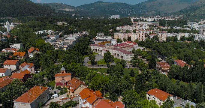 Mostar city and Hrvatski dom Herceg Stjepan Kosača from the air Aerial view, Zoom in
