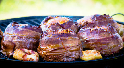 Beer bacon cheese burgers on grill.