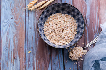 top view of oat flakes in bowl, healthy eating concept 
