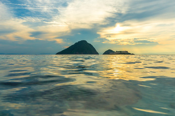 Clear water and sunset background with low angle view