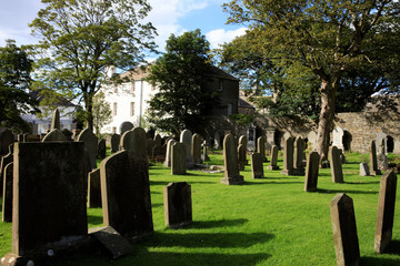Kirkwall - Orkney (Scotland), UK - August 07, 2018: 12th century Romanesque Saint Magnus cathedral cemetery in Kirkwall, Orkney, Scotland, Highlands, United Kingdom