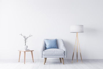 Stylish armchair next to wooden coffee table with white vase, bright grey and blue colors in trendy living room interior. Scandinavian style mockup with empty wall