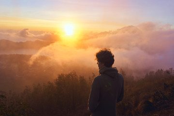 silhouette of man on top of the mountain at sunrise