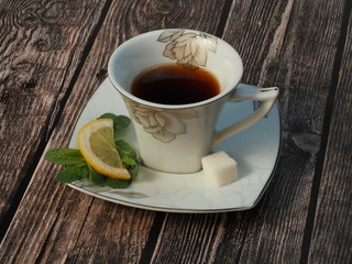 Tea cup with sugar and mint