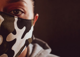 masked man protection against COVID-19 virus, camouflage military mask