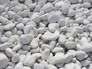 Small, white, chalk pebbles on a beach below the white cliffs of Dover