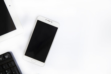 smartphone and computer on a white background top view,.on a white table. Empty place