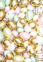 Fototapeta na wymiar Easter eggs golden pastel colored decoration background