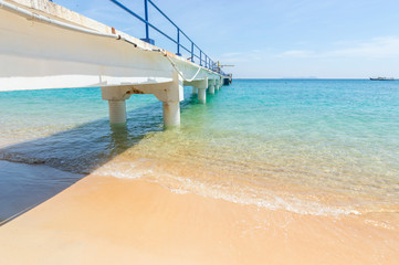 Jetty with clear water and blue skies