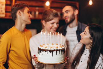 Young people congratulating a pretty woman with birthday at home