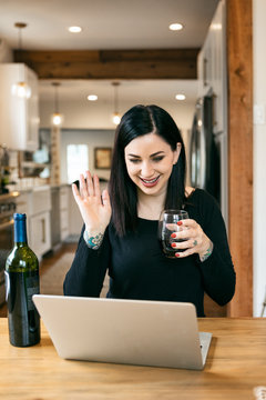 Staying Home: Woman Using Laptop To Have Wine With Friends
