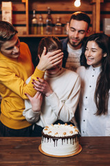 Young people congratulating a pretty woman with birthday at home