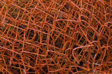 Bingery fabric texture. Ferruginous garrotte pattern. Rusty fencing structure. Ruststained mesh background image.