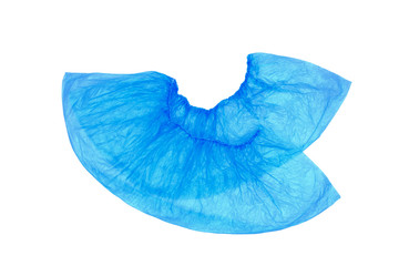An isolated pair, two medical, blue, disposable Shoe covers on a white background. Shoe covers are superimposed on each other with heels.