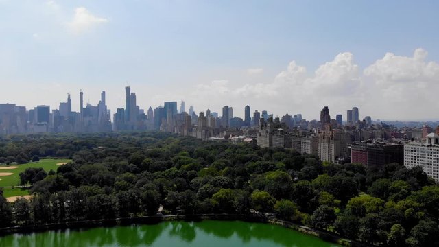 Scenic view of Manhattan island and nature Central Park in American megalopolis - New York, bird's eye view during touristic helicopter tour metropolitan infrastructure during daytime