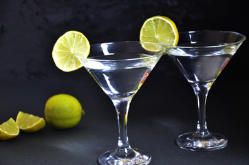 two glasses for making margarita cocktails with lime on a black background Margarita cocktails shot on a bar counter in a nightclub