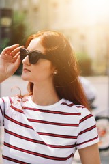 portrait of young woman in black glasses