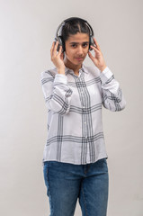 a teenage girl enjoying music  with wireless headphone