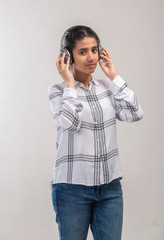 a teenage girl enjoying music  with wireless headphone