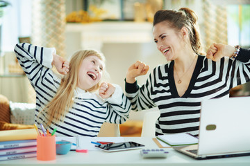 happy mother and child at modern home in sunny day stretching